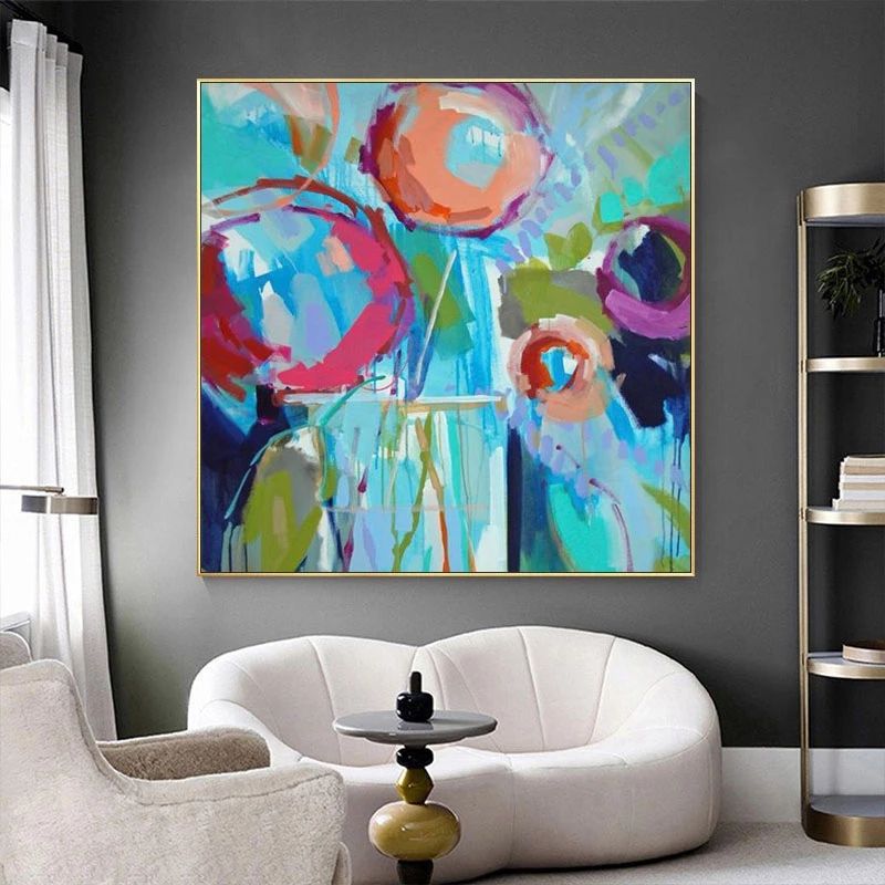 Vibrant hand-painted wall art featuring bold flowers in blue and orange tones, perfect for elevating your home decor.