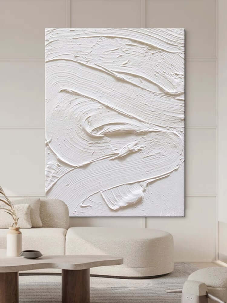 White textured oil painting abstract artwork hung in a modern living room, showcasing minimalist design and intricate surface detail.