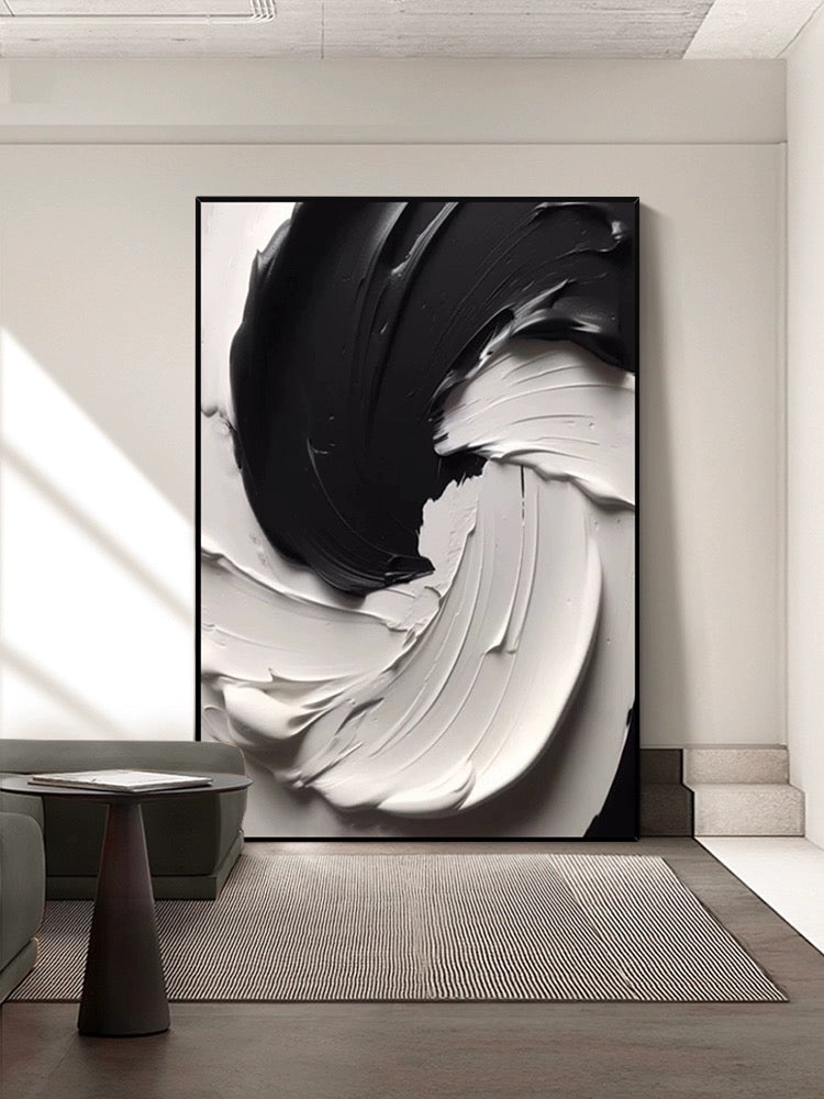 Black and white textured wall art featuring thick paint layers, creating dynamic movement and rugged terrain.