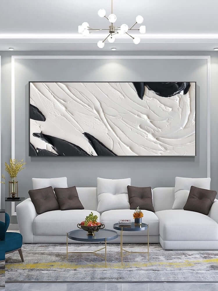 Arte de pared texturizado en blanco y negro sobre el sofá