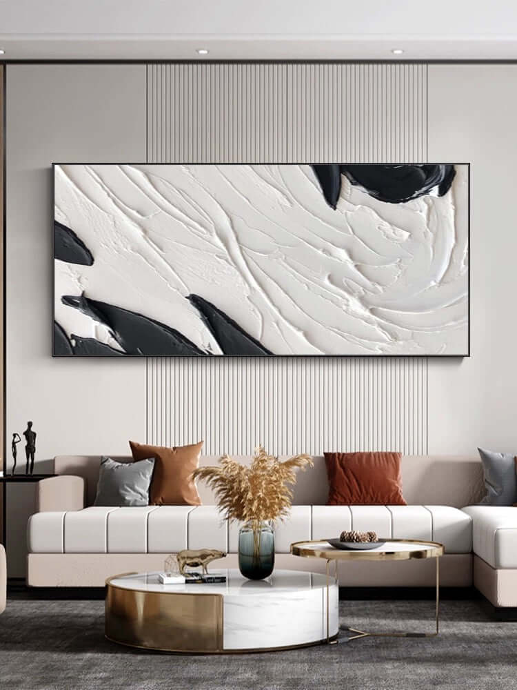 Arte de pared texturizado en blanco y negro sobre el sofá
