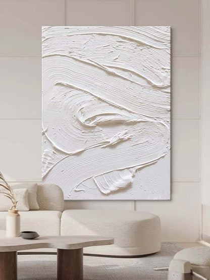 White textured oil painting abstract artwork hung in a modern living room, showcasing minimalist design and intricate surface detail.