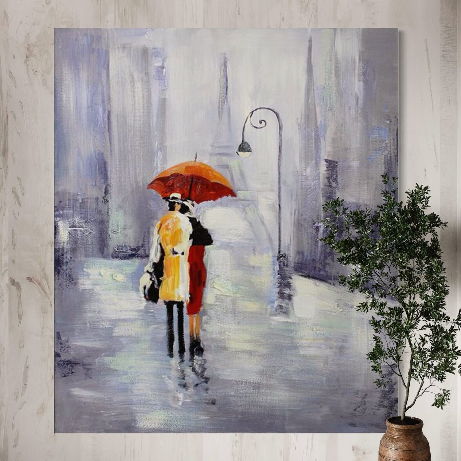 Hand-painted wall art featuring a couple under an orange umbrella in a rainy Paris street, by Kline Collective®.