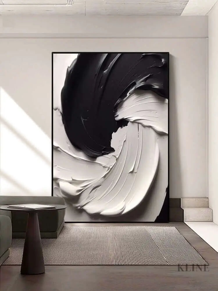 Black and white textured wall art featuring thick paint layers, creating dynamic movement and rugged terrain. 