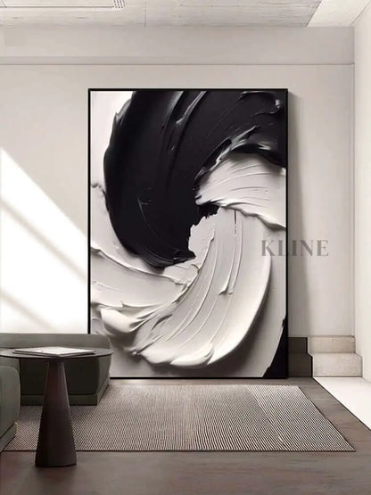 Black and white textured wall art featuring thick paint layers, creating dynamic movement and rugged terrain.