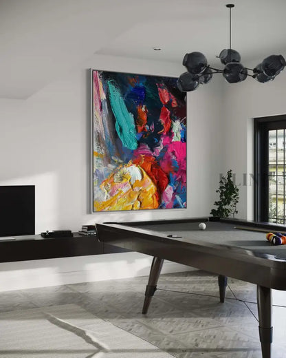 Vibrant hand-painted wall art in a modern game room, enhancing the space with color and creativity.