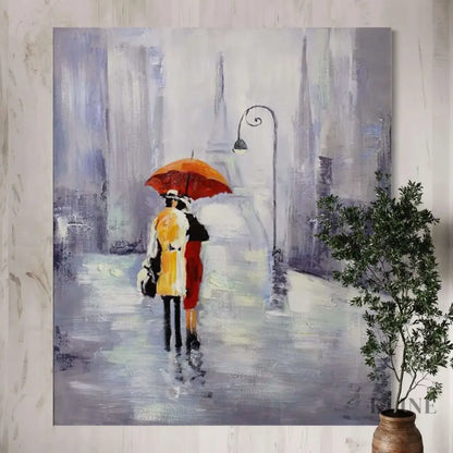 Hand-painted wall art featuring a couple under an orange umbrella in a rainy Paris street, by Kline Collective®.