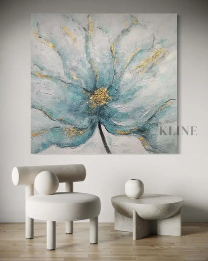 Artwork of a blue floral piece featuring gold accents, enhancing a modern interior design aesthetic.