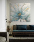Elegant abstract flower painting with gold accents in a serene living room setting.