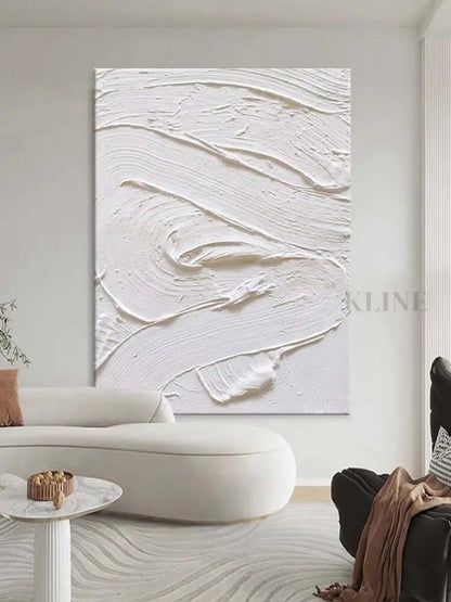 White textured oil painting on wall, showcasing minimalism and intricate details in a modern living room.