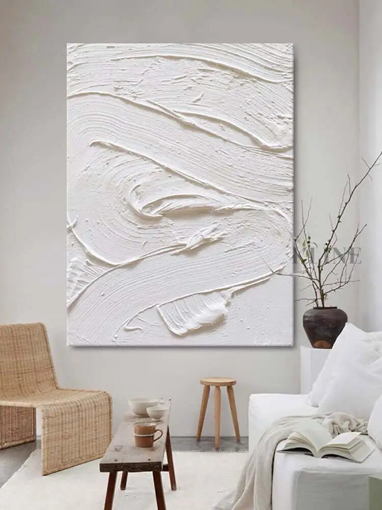 White textured oil painting on wall in modern minimalist living room, showcasing abstract art with rich depth.