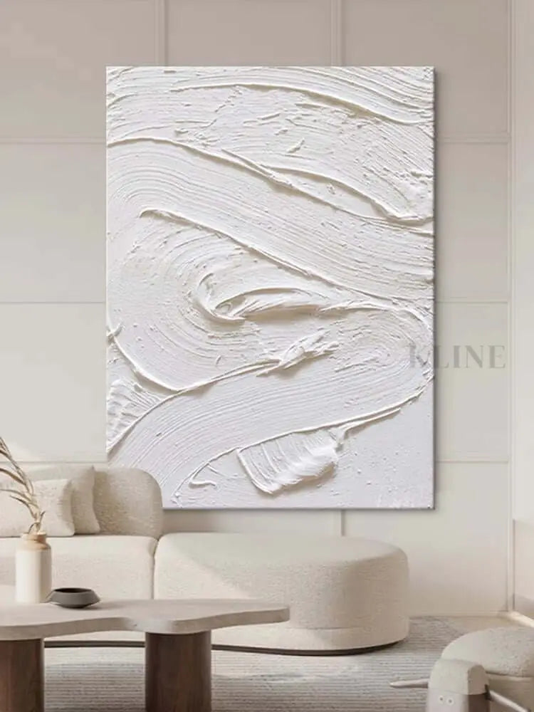 White textured oil painting abstract artwork hung in a modern living room, showcasing minimalist design and intricate surface detail.