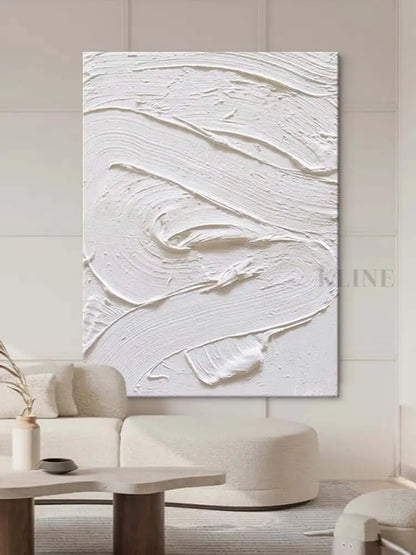 White textured oil painting abstract artwork hung in a modern living room, showcasing minimalist design and intricate surface detail.