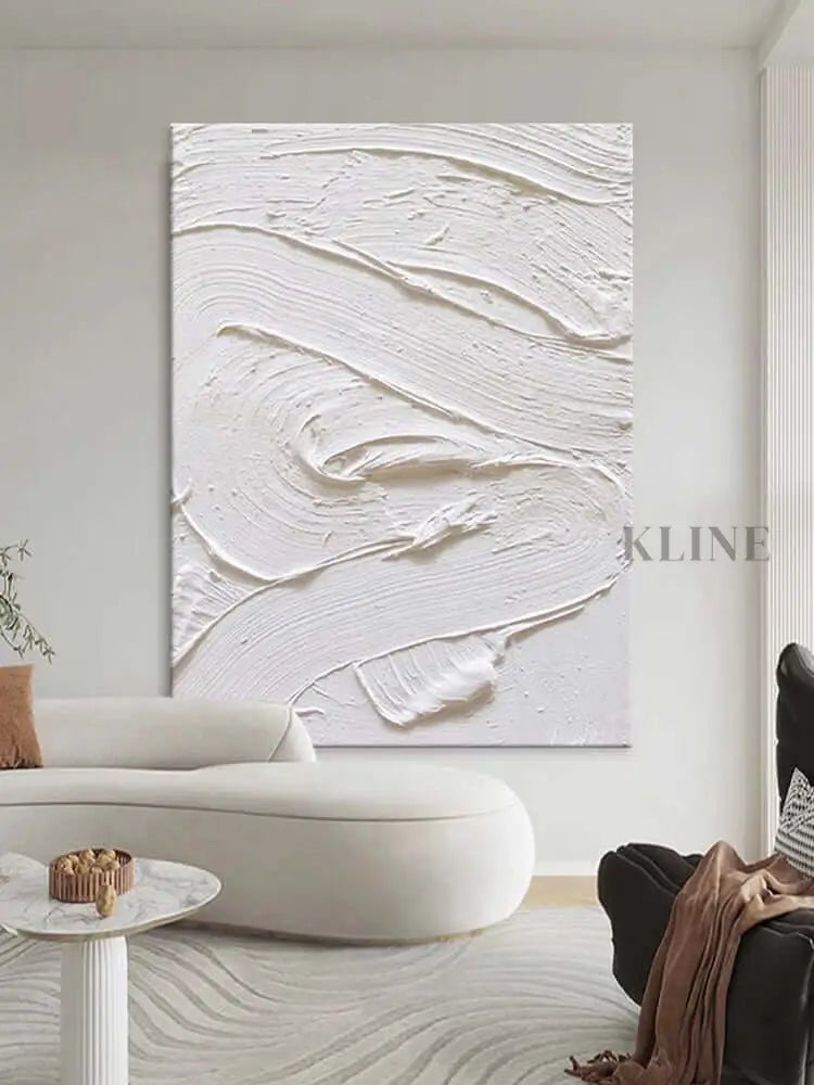 White textured oil painting on wall, showcasing minimalism and intricate details in a modern living room.