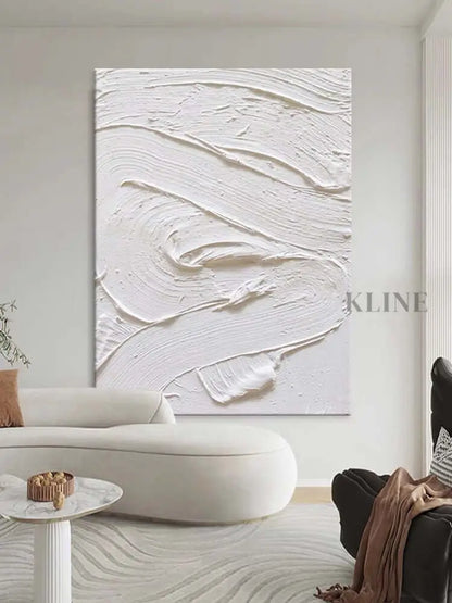 White textured oil painting on wall, showcasing minimalism and intricate details in a modern living room.