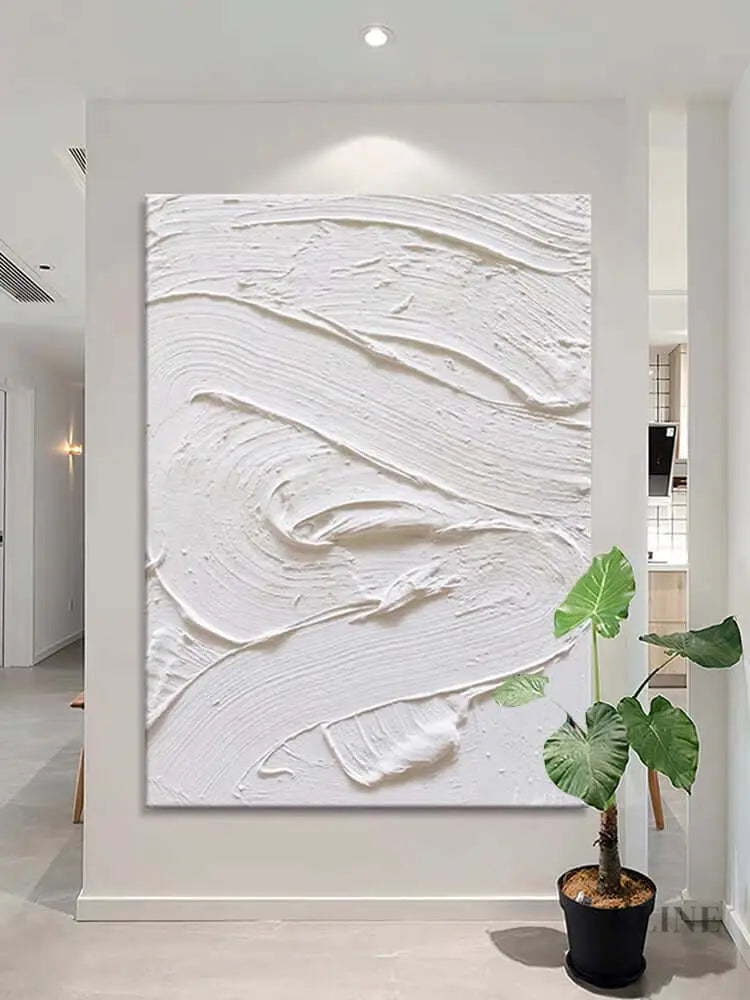 White textured oil painting on a wall, showcasing minimalism and abstract design in an elegant interior. 
