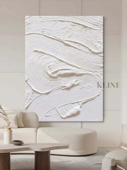 White textured oil painting abstract artwork hung in a modern living room, showcasing minimalist design and intricate surface detail.