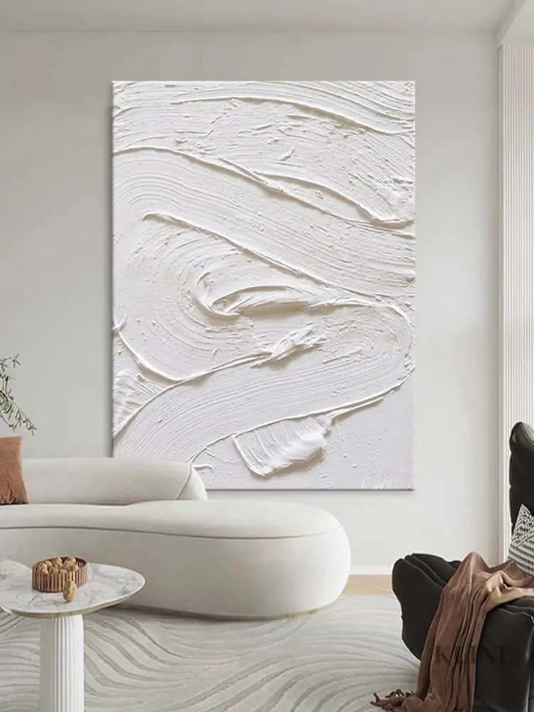 White textured oil painting on wall, showcasing minimalism and intricate details in a modern living room.